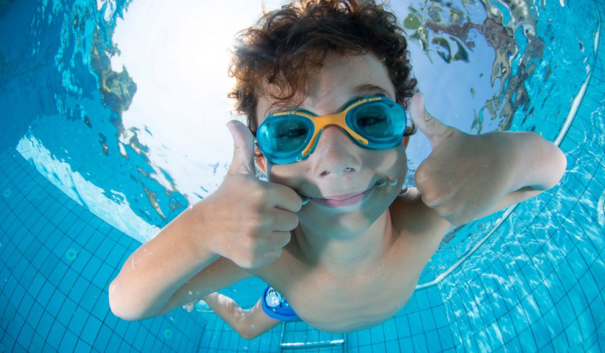 Kind taucht in Pool